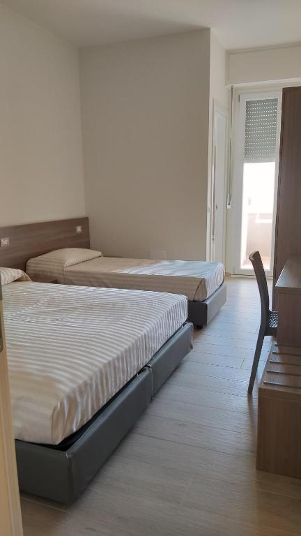 Łóżko lub łóżka w pokoju w obiekcie HOTELRISTORANTE IL PUNTO