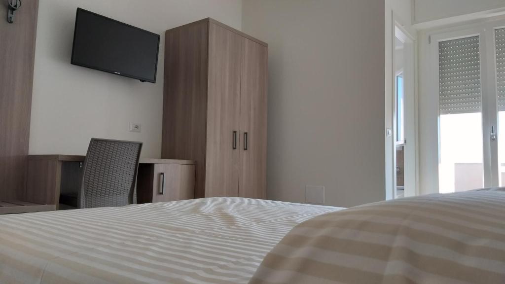 Łóżko lub łóżka w pokoju w obiekcie HOTELRISTORANTE IL PUNTO
