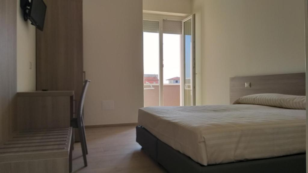 Łóżko lub łóżka w pokoju w obiekcie HOTELRISTORANTE IL PUNTO