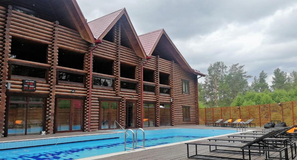 a house with a pool in front of it at Park-Hotel Chusovaya in Sloboda