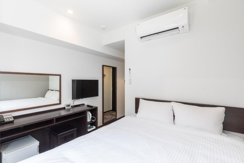 Postel nebo postele na pokoji v ubytování Hotel Tetora Kyoto Station