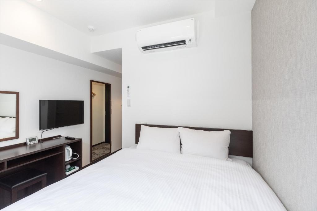 Postel nebo postele na pokoji v ubytování Hotel Tetora Kyoto Station