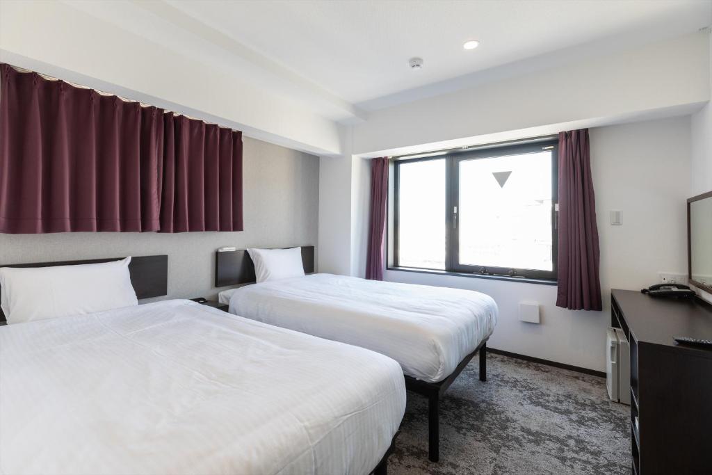 Postel nebo postele na pokoji v ubytování Hotel Tetora Kyoto Station