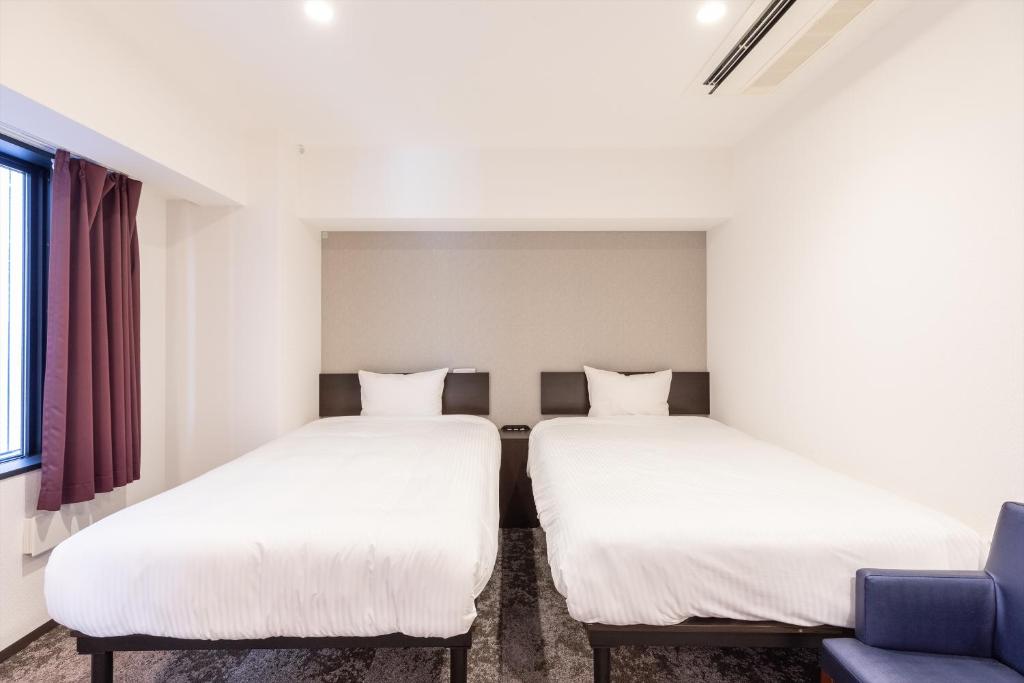 Postel nebo postele na pokoji v ubytování Hotel Tetora Kyoto Station