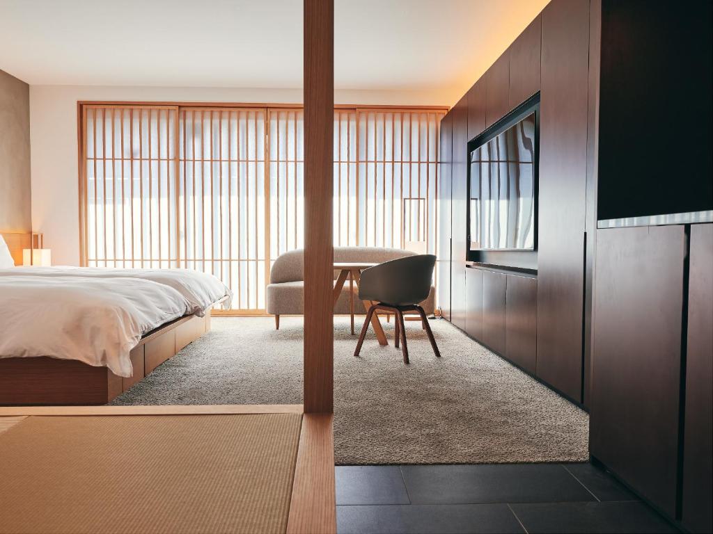 Postel nebo postele na pokoji v ubytování nol kyoto sanjo
