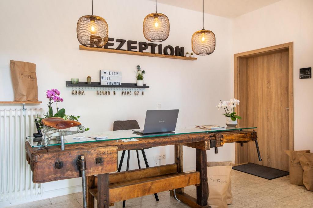 an office with a desk with a laptop on it at Hotel Clement - Bed & Breakfast in Ingelheim am Rhein