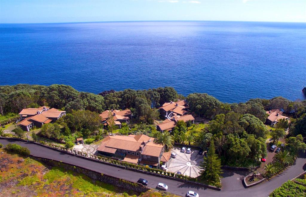 an aerial view of a house by the water at Aldeia da Fonte Hotel in Lajes do Pico