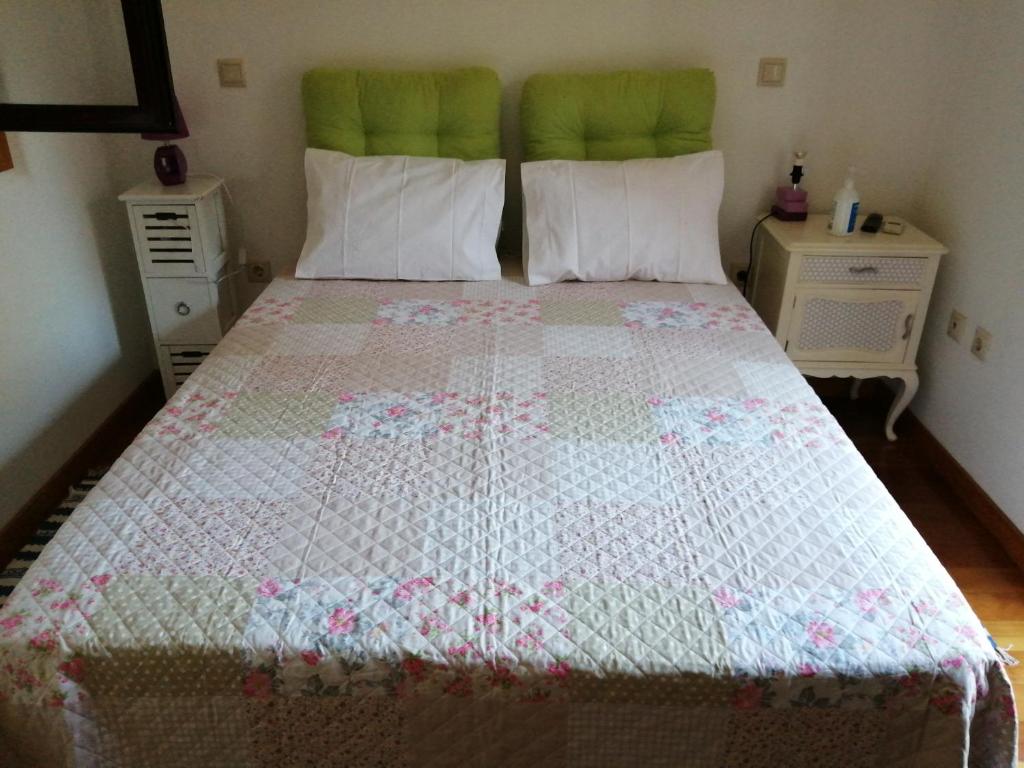 um quarto com uma cama com uma colcha em VianasHome em Amarante