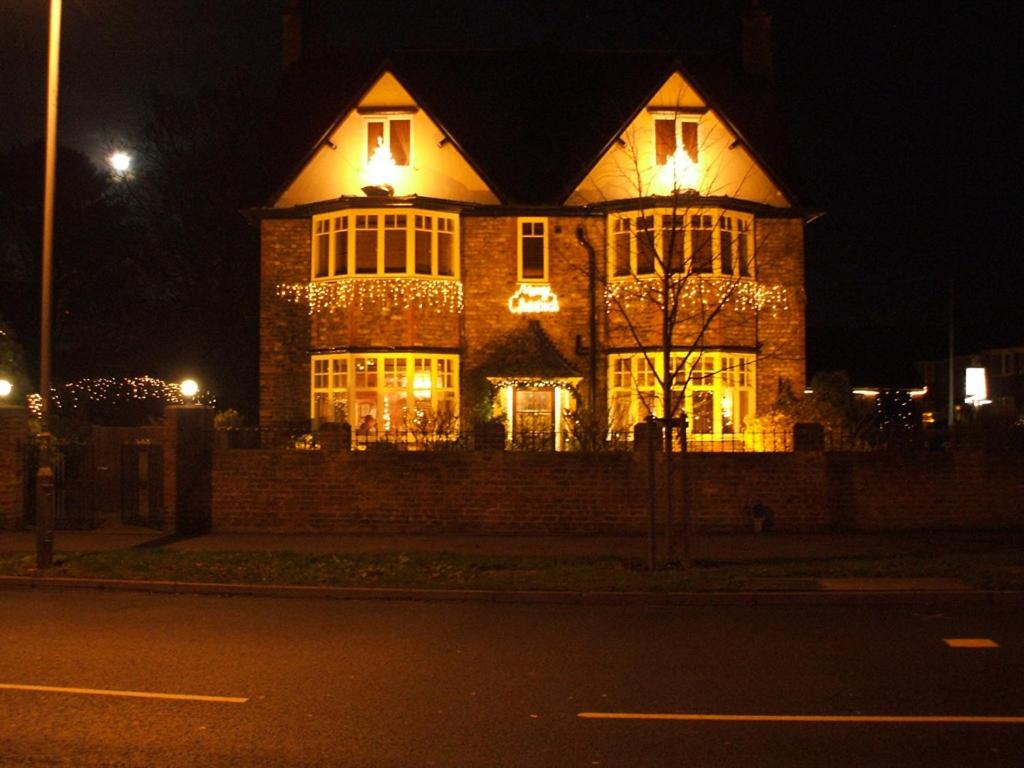 a large house with lights on it at night at The Limes in York