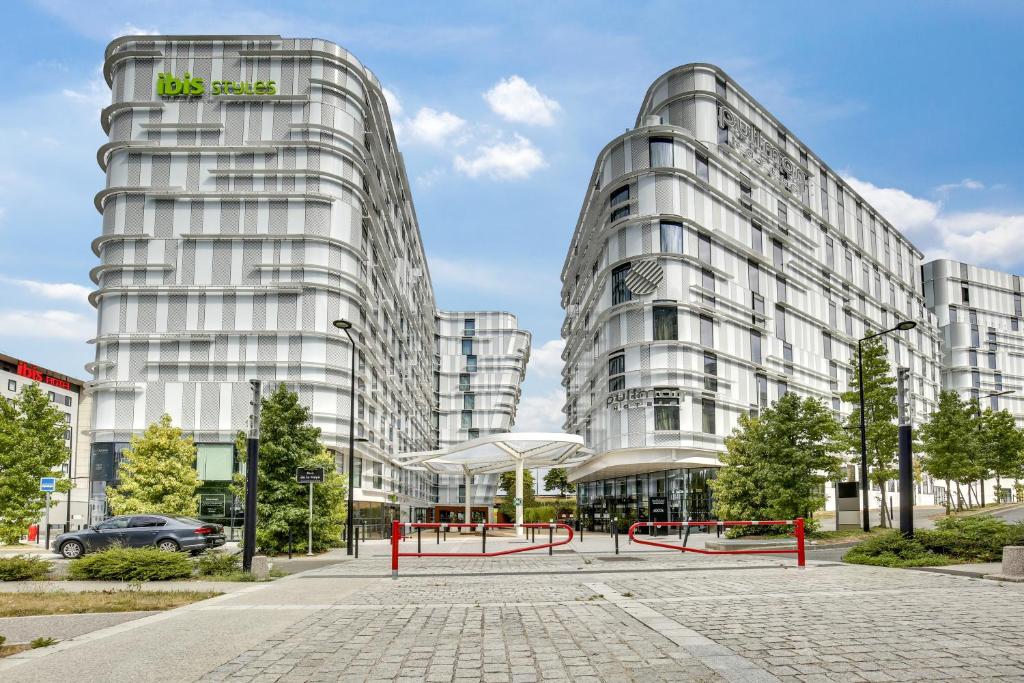 two tall glass buildings in a city at ibis Styles Paris Charles de Gaulle Airport in Roissy-en-France
