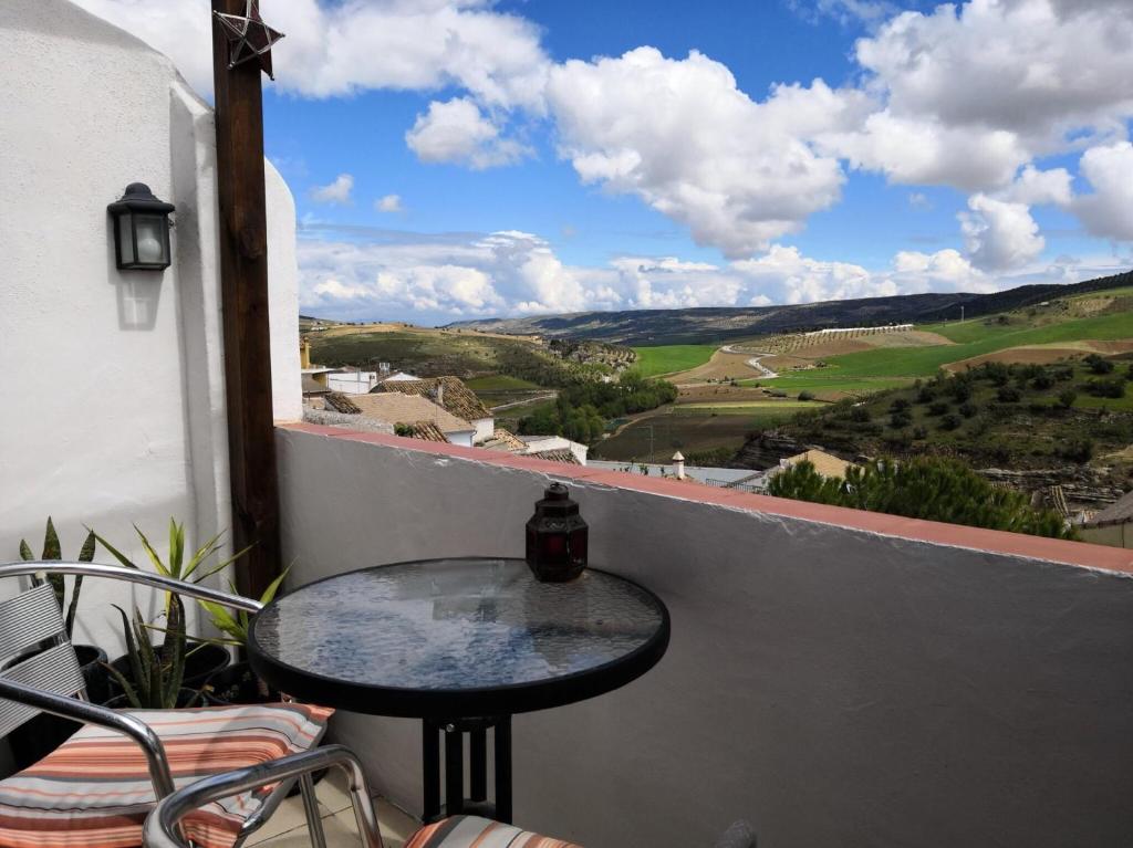 a table on a balcony with a view of the countryside at Casa Cervantes in Alhama de Granada