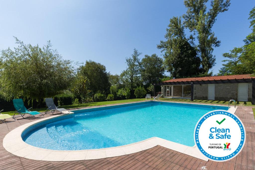 a swimming pool with a sign that says clean and safe at Boutique Country House w/ Pool by Host Wise in Travanca