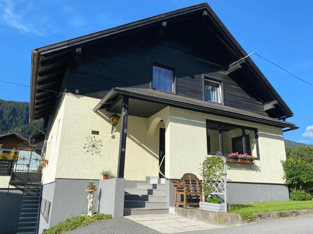 a small house with a black roof at Chalet 48 in Hermagor