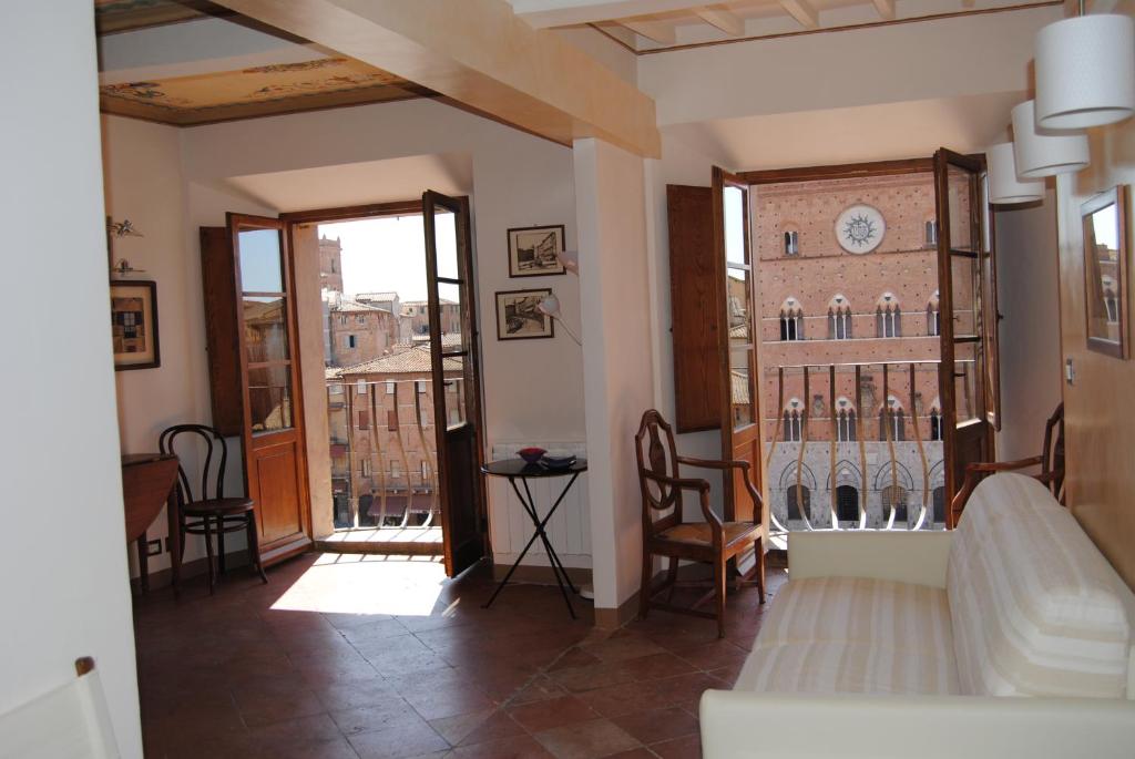 a living room with a clock on the wall at I Balconcini in Siena