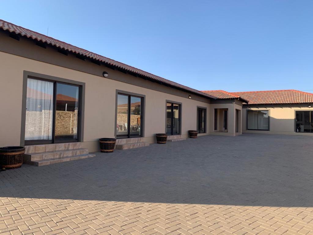 a building with a lot of windows and a courtyard at Bread & Barrel Eureka Kimberley in Kimberley