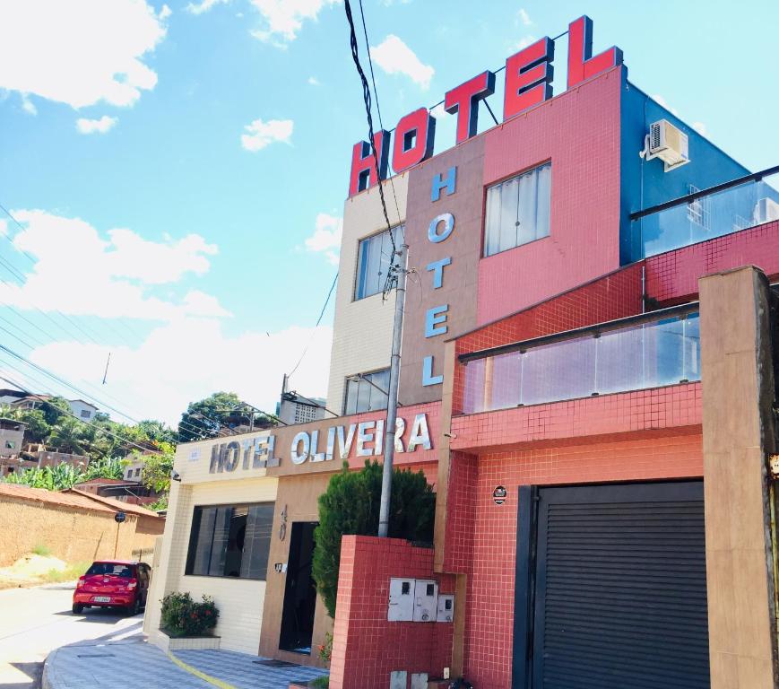 a building with a sign on the side of it at Hotel Oliveira - By UP Hotel in Ipatinga