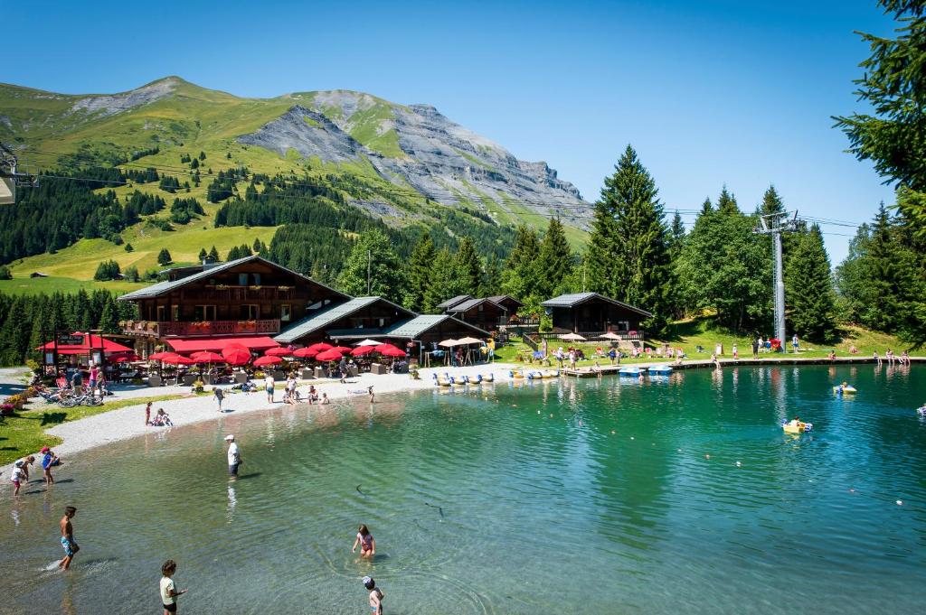 a group of people on a beach in a lake at Chalet-Hôtel de l&#39;Etape in Les Contamines-Montjoie