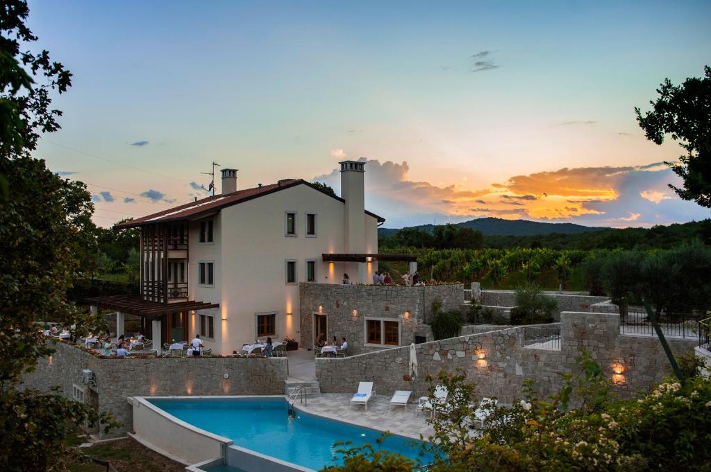Málchina的住宿－Cardo Boutique&Wine Resort，日落时分带游泳池的别墅