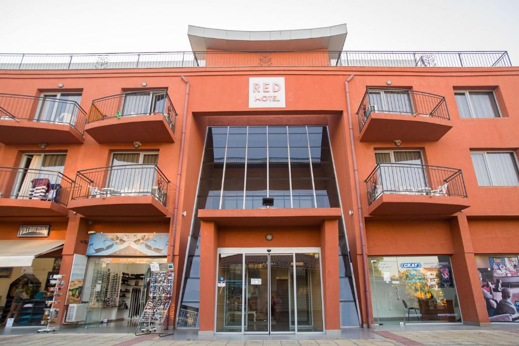 an orange building with balconies on top of it at Хотел РЕД in Lozenets