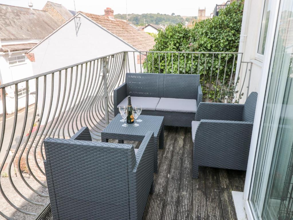 a balcony with two chairs and a table at Huffin in Dartmouth