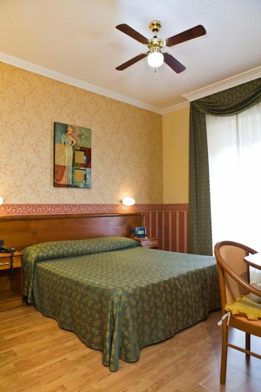 Postel nebo postele na pokoji v ubytování Hotel Verdi