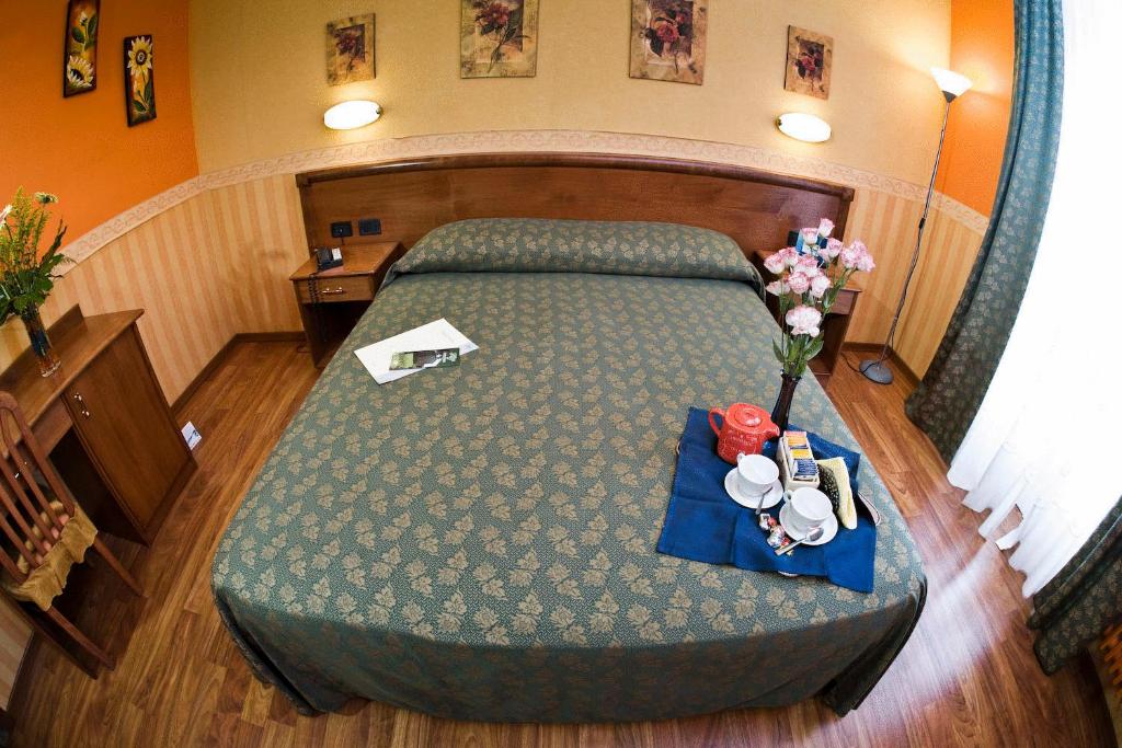 Postel nebo postele na pokoji v ubytování Hotel Verdi