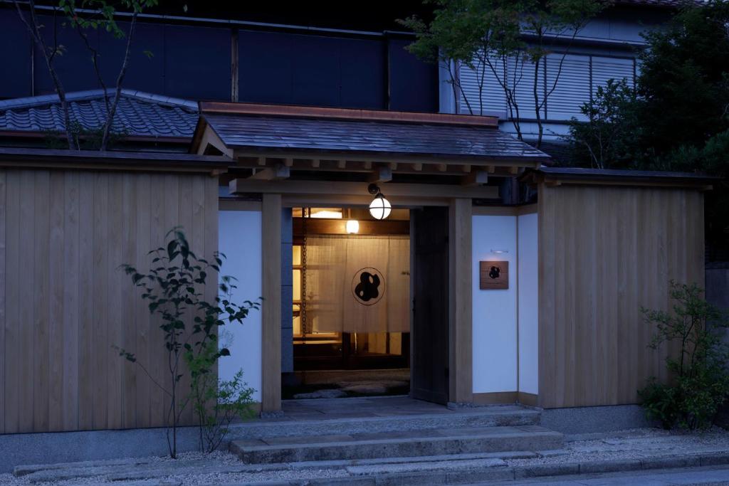 a entrance to a house with a light at night at MARUYO HOTEL in Kuwana