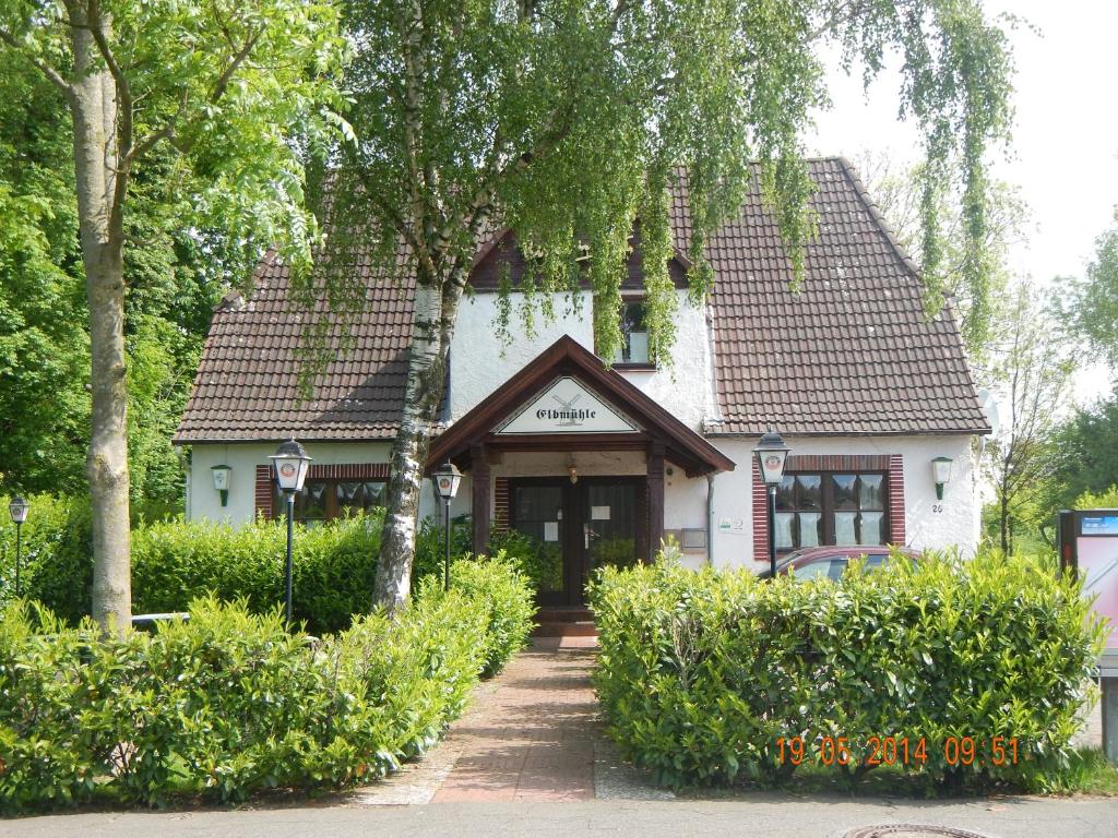 a white house with a brown roof at Hotel Elbmühle in Sankt Margarethen