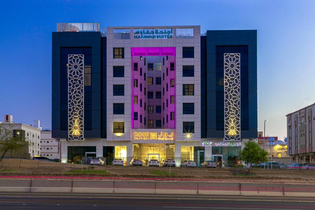 a building with two towers with lights on it at Hafawah Suites in Medina