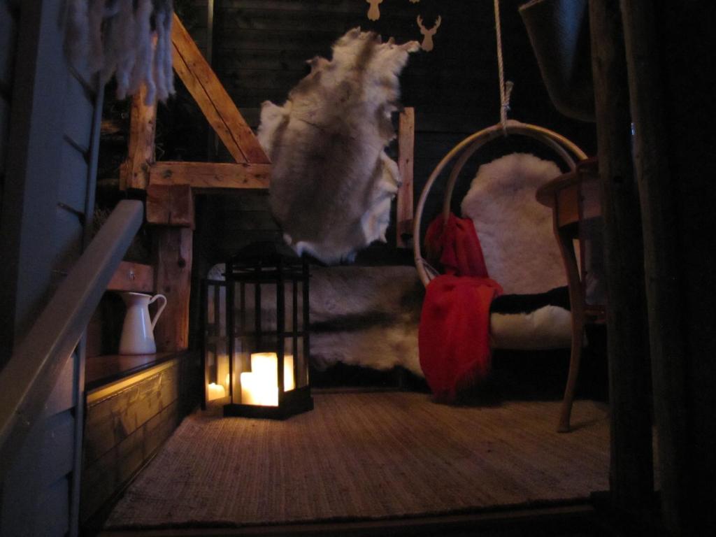 a dark room with a dog sitting on a bed at B&B uniikki majoitus maalaisidyllissä in Tervola