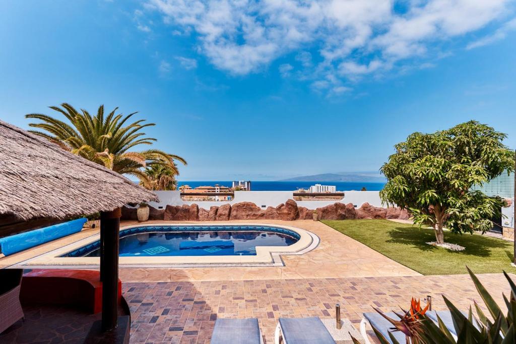 a resort pool with a view of the ocean at Villas Anais in Callao Salvaje
