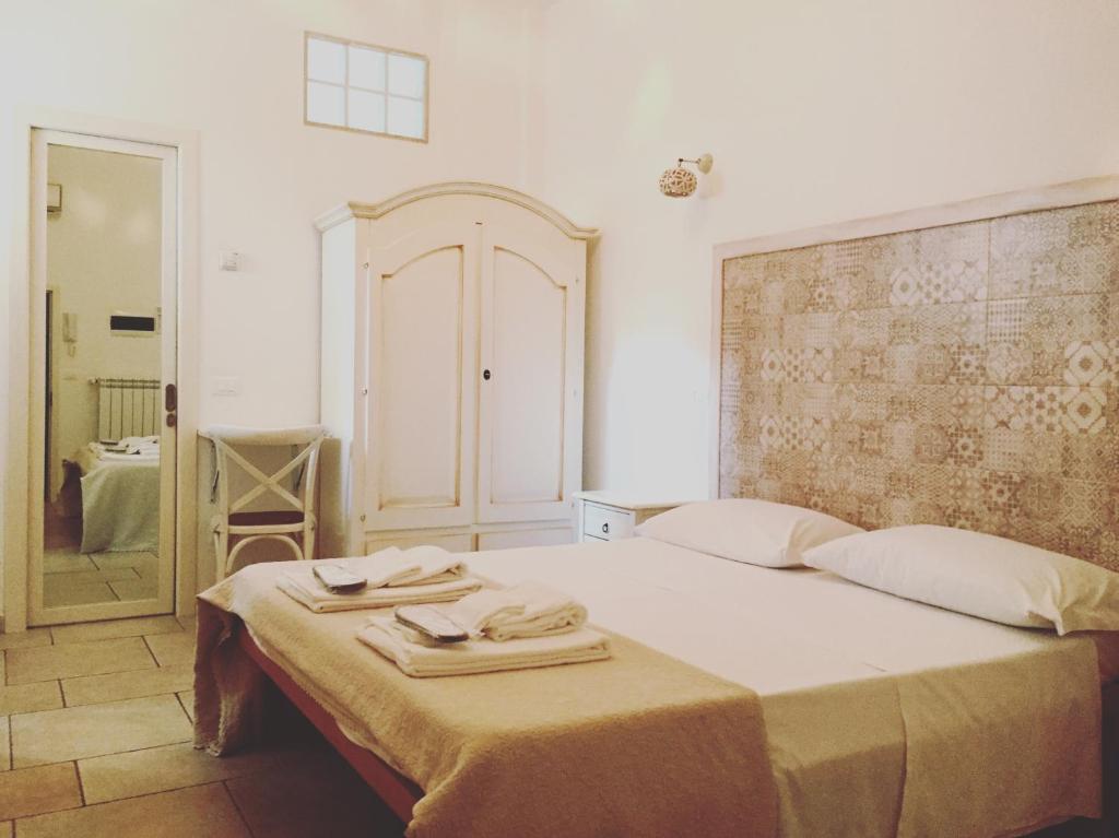 a bedroom with a bed with two towels on it at Donna Nina in Monopoli