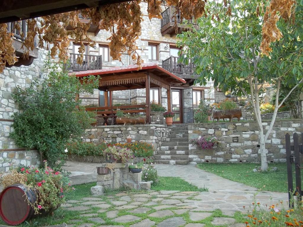 a stone building with a gazebo in a garden at T'Asprolithia in Kalyvia Fylaktis