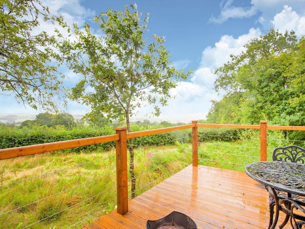 a wooden deck with a table and chairs on it at Vintage Holiday home in Welshpool with Garden in Welshpool