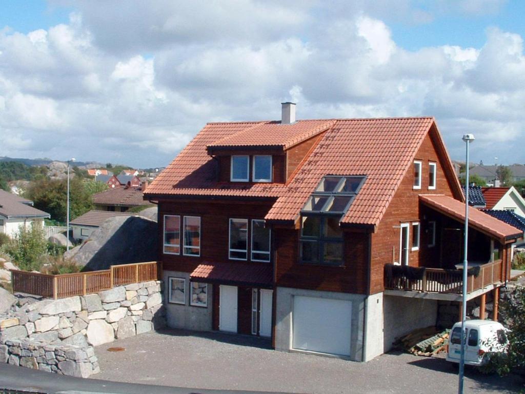een stenen huis met een rood dak bij Four-Bedroom Holiday home in Sirevåg in Sirevåg