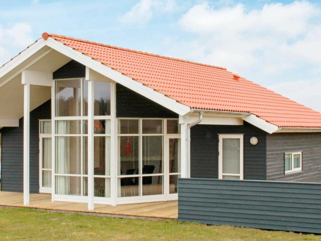 a house with an orange roof at 8 person holiday home in Ulfborg in Fjand Gårde