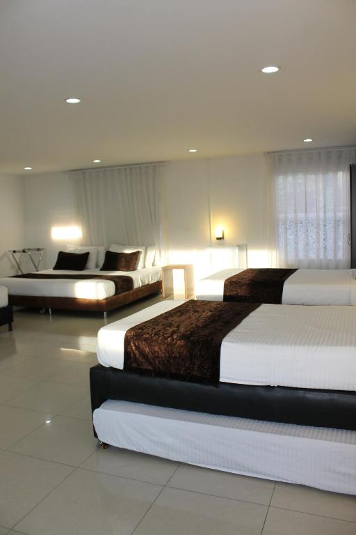 Uma cama ou camas num quarto em Hotel Boutique las Rosas 5 G