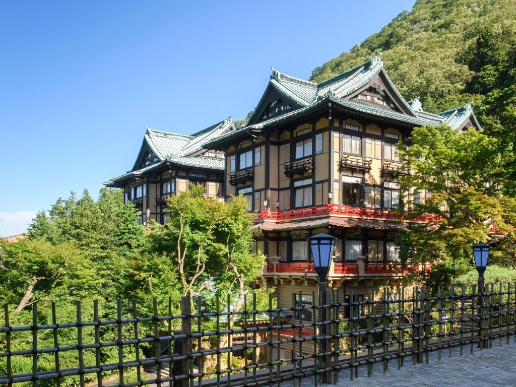a large building with a black fence in front of it at Fujiya Hotel in Hakone