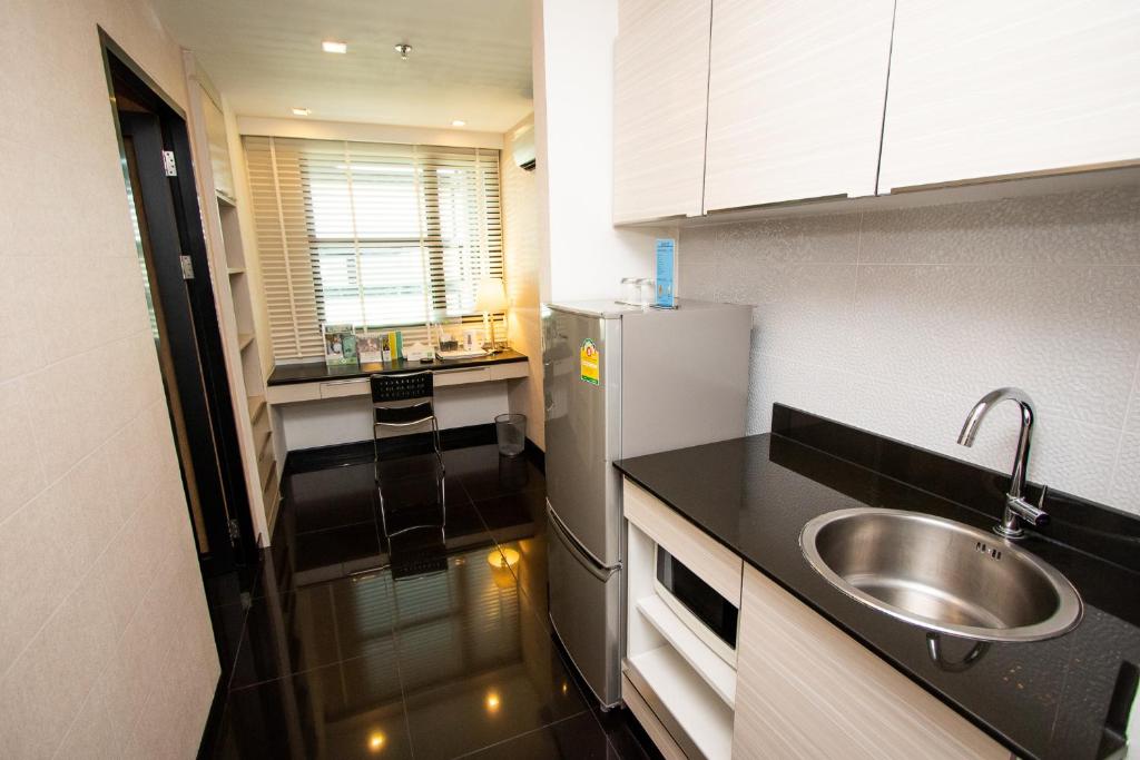 A compact kitchenette runs along one wall of the apartment-style room.