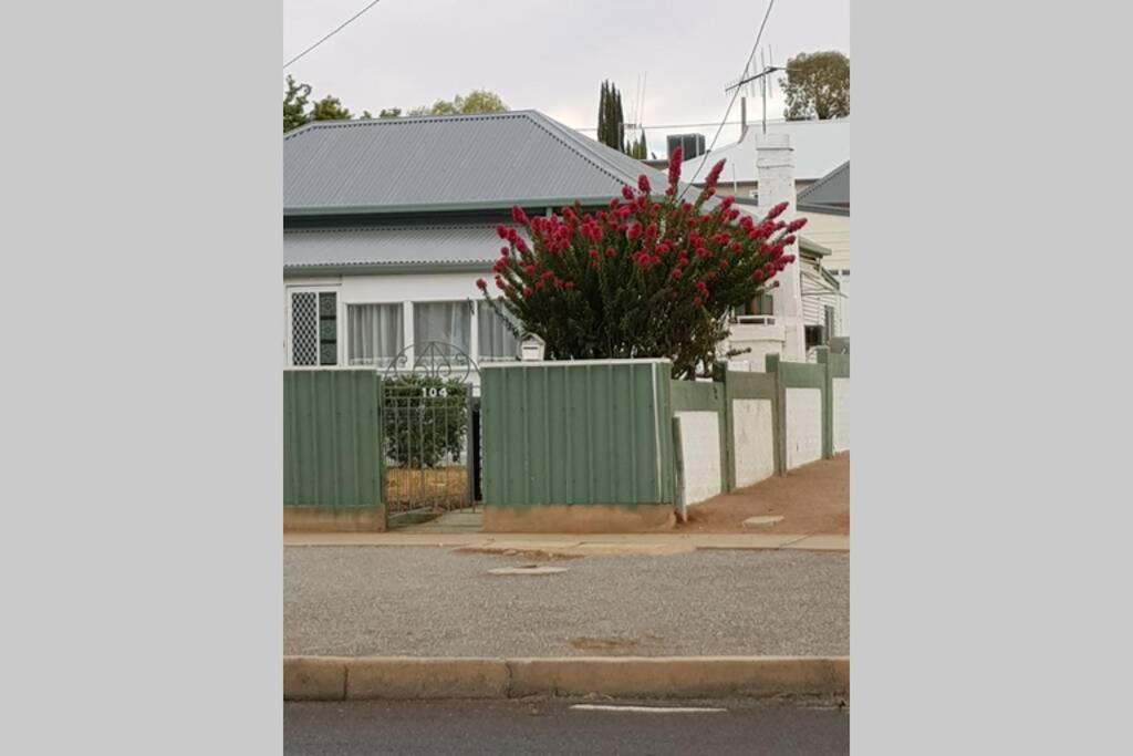 a street view of a house with a fence at The Comfort Cottage on Williams in Broken Hill