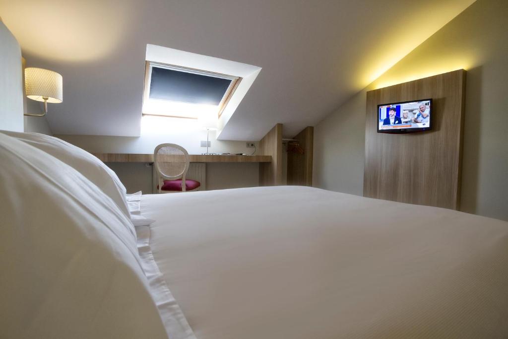 Postel nebo postele na pokoji v ubytování Hotel Los Lagos Nature