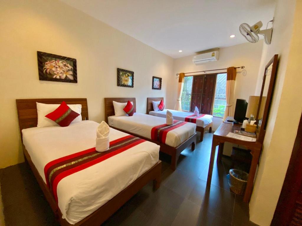 Postel nebo postele na pokoji v ubytování Home Inn Pai Garden
