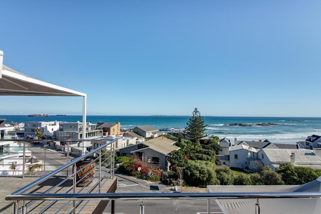 a view of the ocean from a balcony at Blaauw Village Guest House in Bloubergstrand