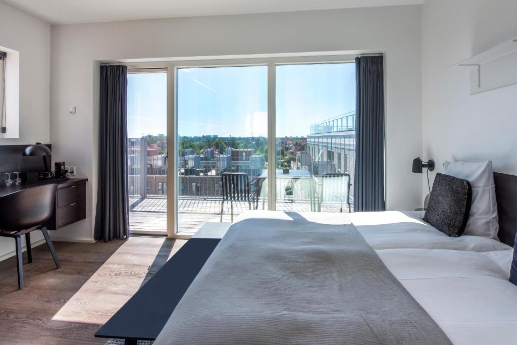 Postel nebo postele na pokoji v ubytování CPH Studio Hotel