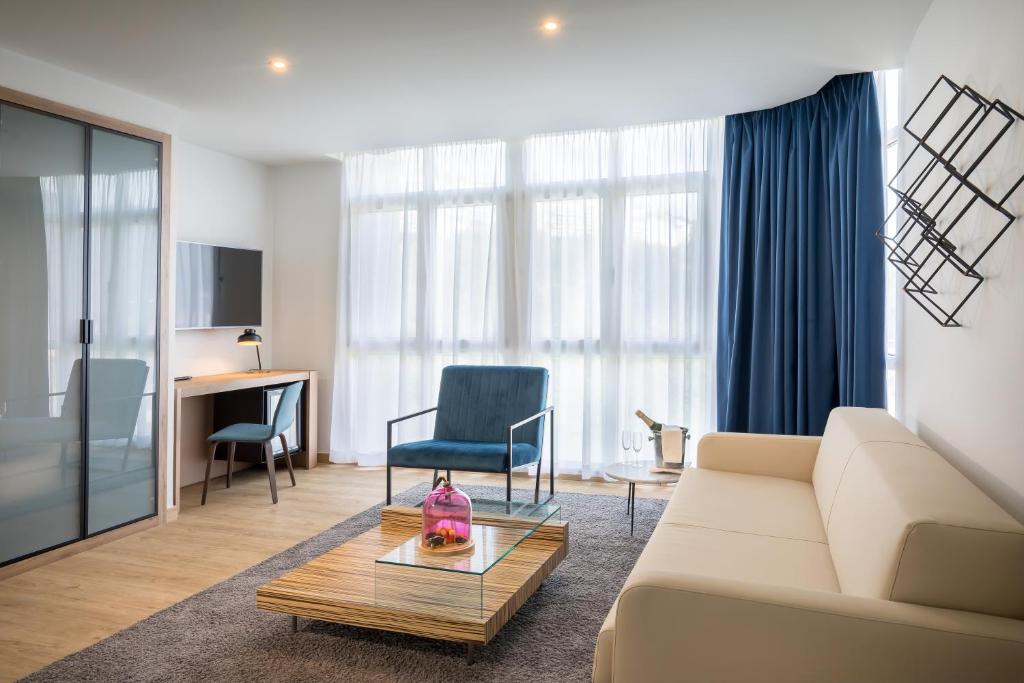 a living room with a couch and a table at Barceló Costa Vasca in San Sebastián
