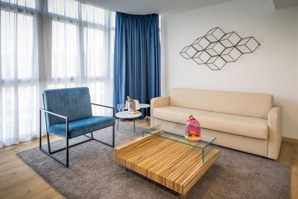 a living room with a couch and a chair at Barceló Costa Vasca in San Sebastián