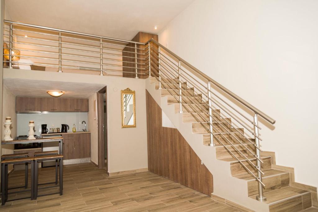a staircase in a living room with a kitchen at YourCastle in Alexandroupoli