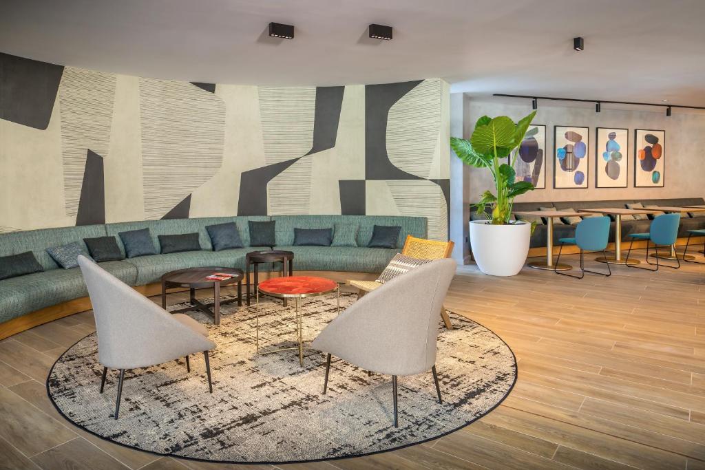 a living room with a couch and chairs and tables at Barceló Costa Vasca in San Sebastián
