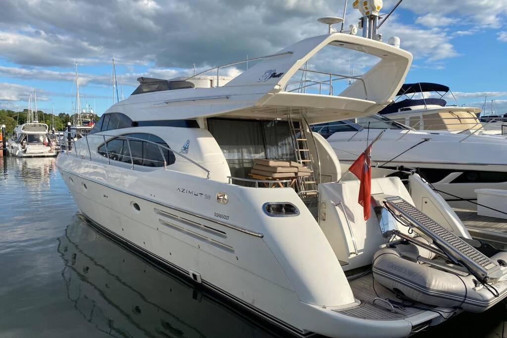 a white boat docked at a dock in the water at Italian Superyacht Bianca Lucida in London