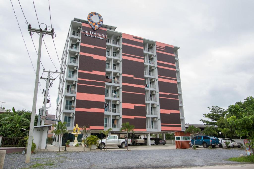 a large building with a red and black facade at The Seasons in Pathum Thani